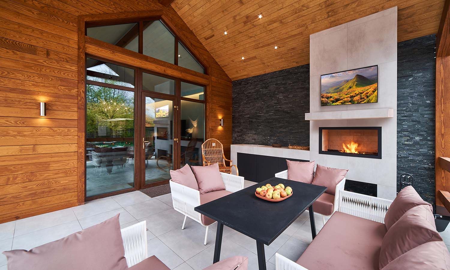 a beautiful modern porch with wooden walls and pink furniture