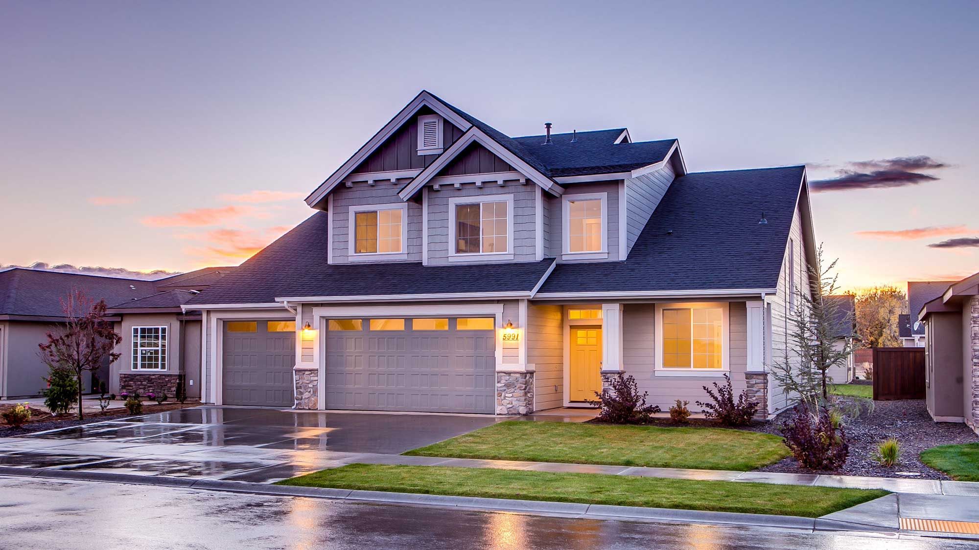 blue suburban home at dusk