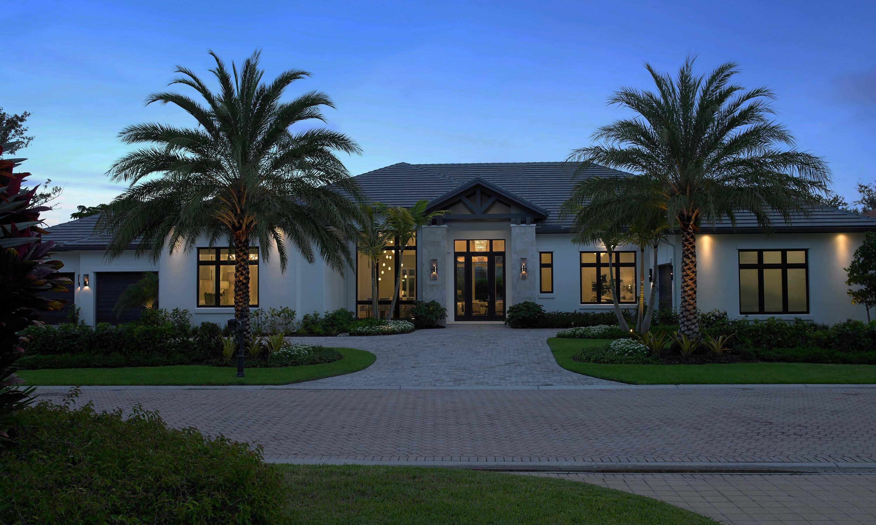 house exterior florida home two palm trees at dusk