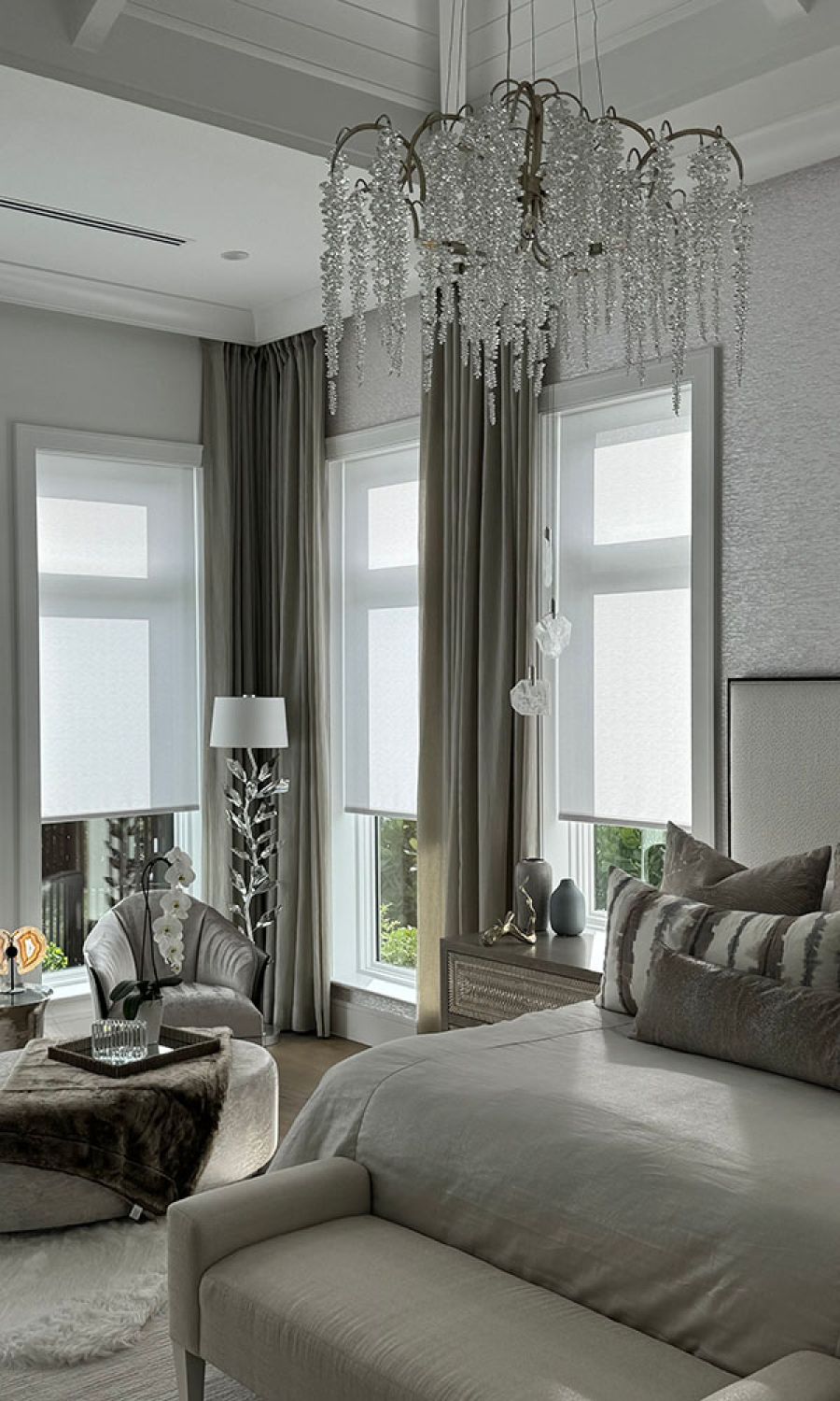 Beige room with neutral curtains and chandelier