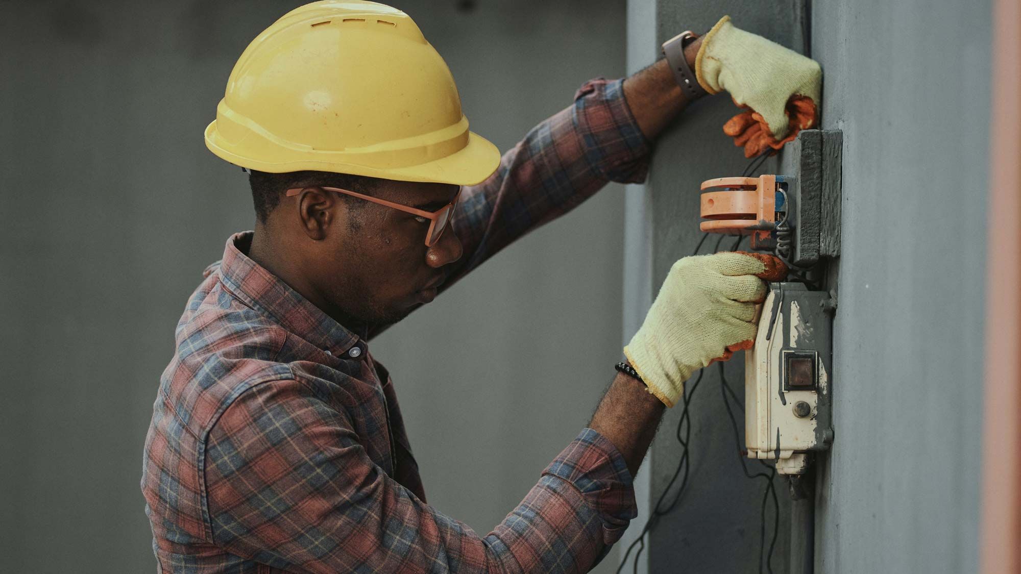 man in hard hat working on an electrical box