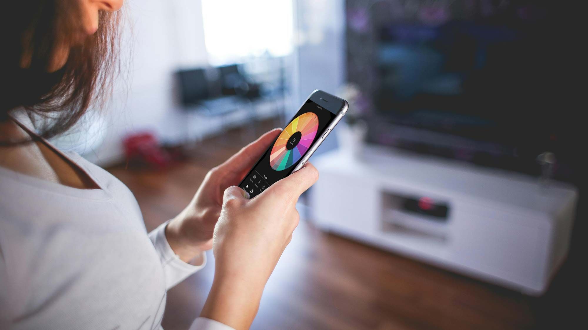 woman interacting with phone with color wheel on it