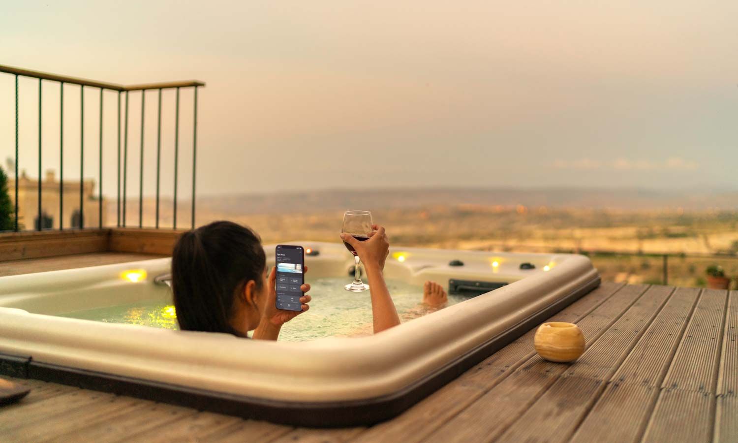 a woman on her phone while she relaxes in a hot tub