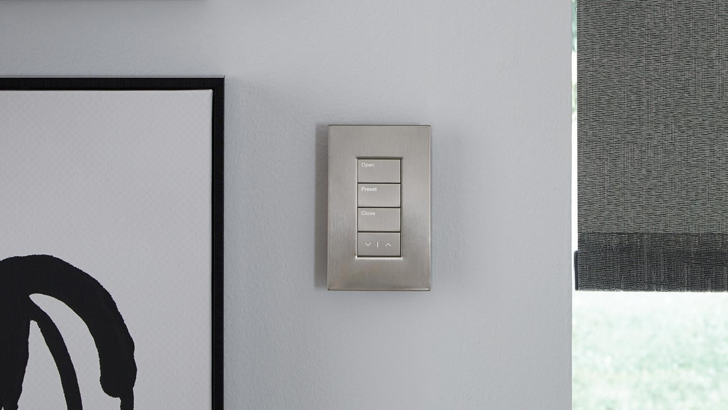 silver keypad from lutron on a white wall